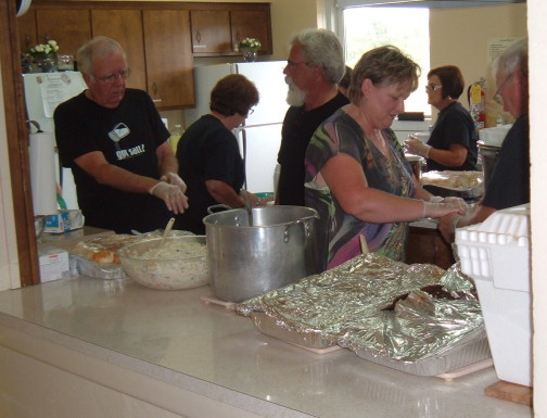 Members prepare food for the annual Samaritan Fund benefit dinner.